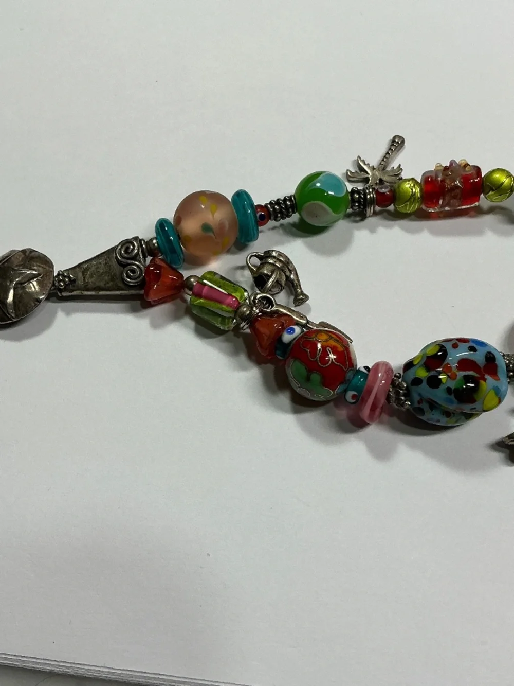 Sterling Silver and Lampwork glass beads W/ 4 Sterling Silver charms. 7.5” long